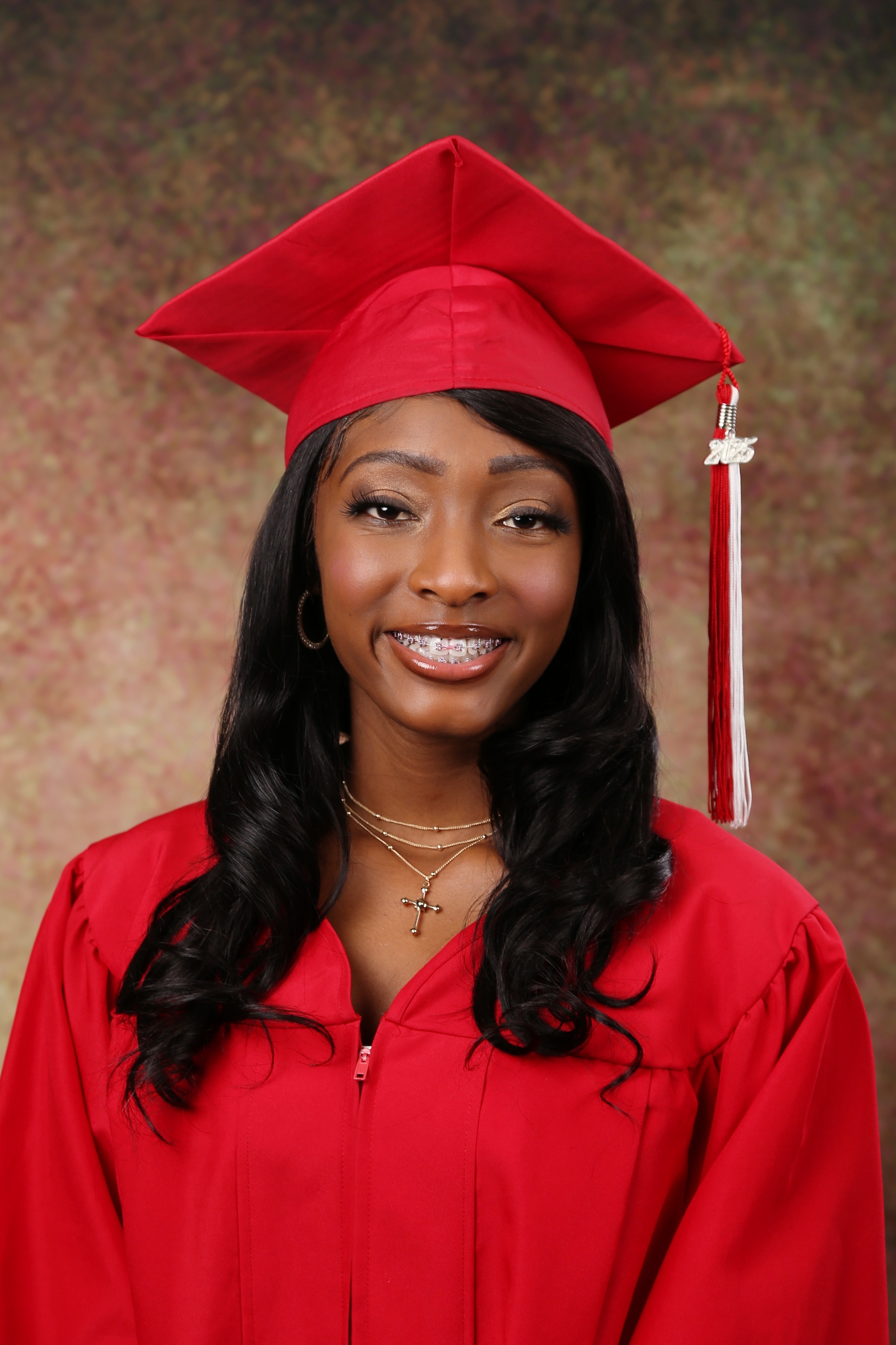 High school senior in red cap and gown — graduation portrait